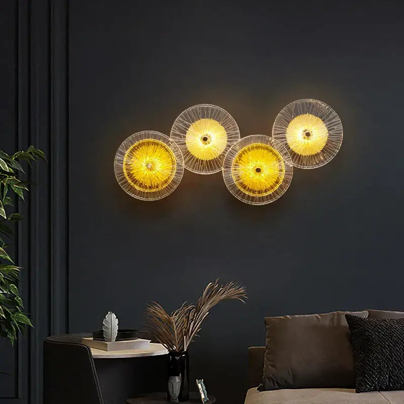 Set of four modern golden radial crystal wall lamps with translucent yellow glass shades and intricate wireframe design for decorbites crystal wall lamp decor