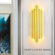 Modern golden radiant led wall lamp featuring vertical cylindrical rods in a stylish decorbites led wall sconce design