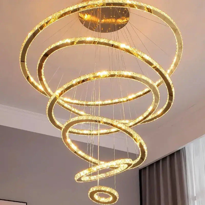 Modern golden spiral crystal stair chandelier with crystal-encrusted rings and warm led lighting for living room