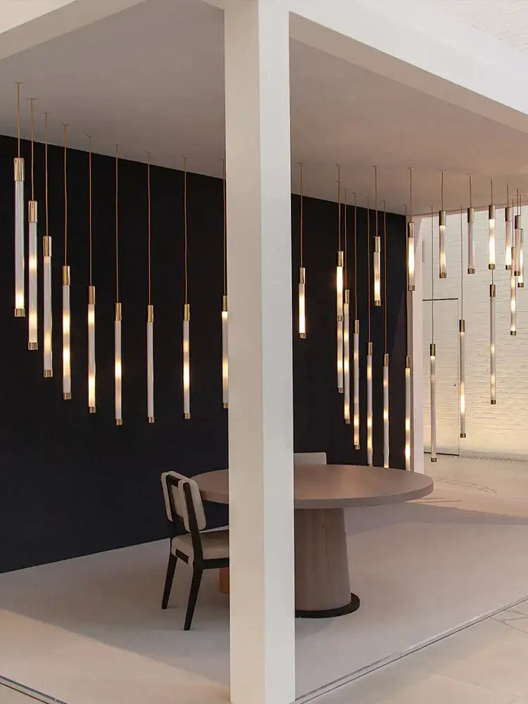 Modern golden tube chandelier with cylindrical LED glass lights and gold-toned accents for sleek decorbites golden decor