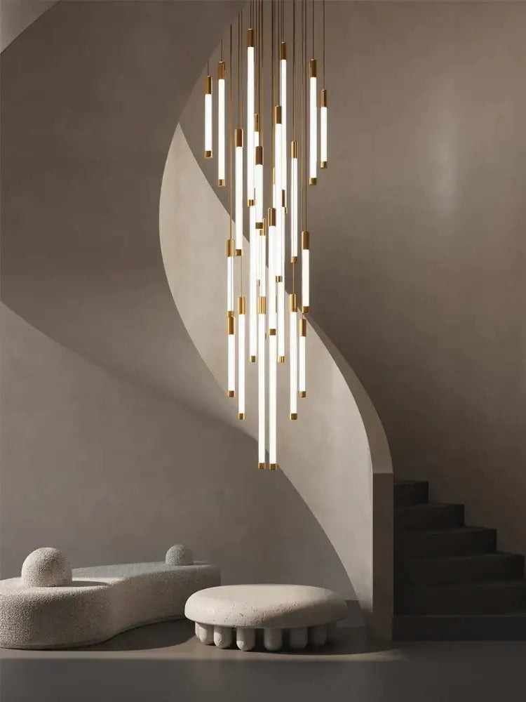 Modern golden tube chandelier with slender vertical cylindrical tubes in warm gold and white finish by decorbites golden tube
