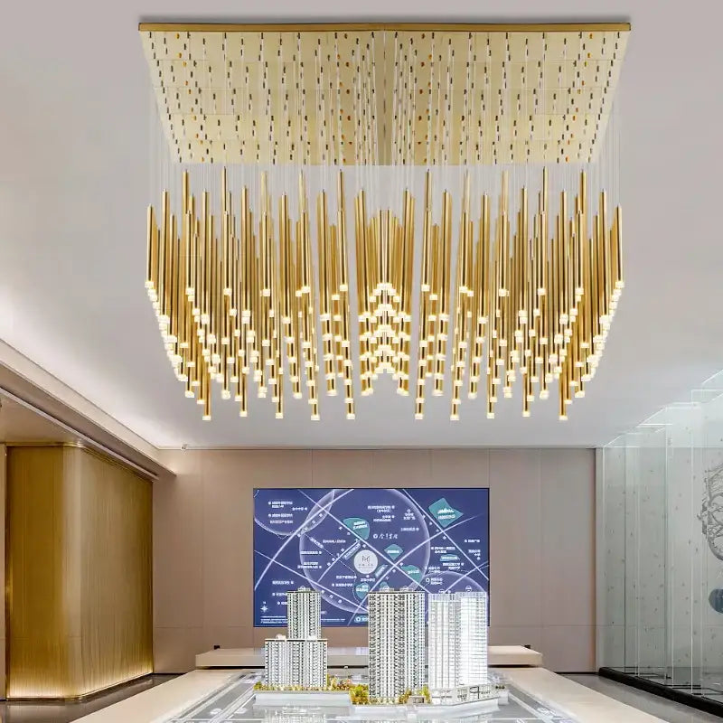 Modern golden tube led chandelier with rectangular top panel and cascading cylindrical fixtures for living room decorbites golden tube