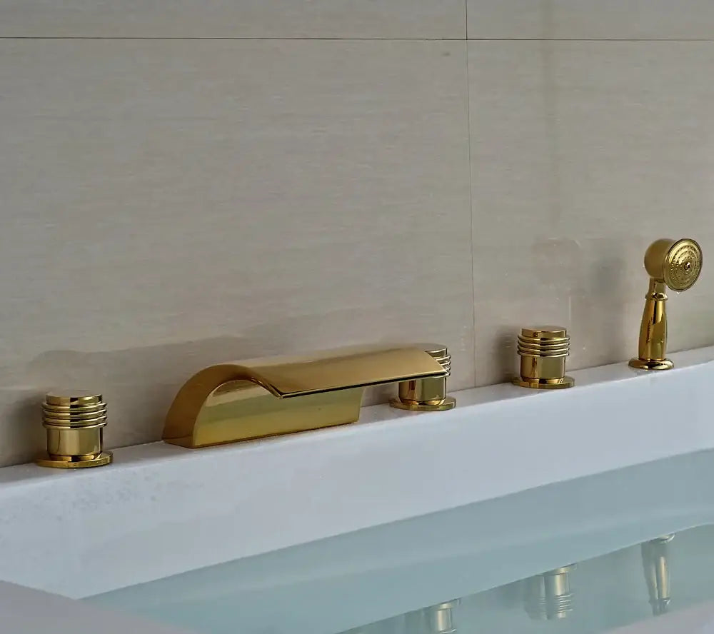 Modern golden widespread brass bathtub faucet set with sleek curved spout and two cylindrical handles for bathroom use