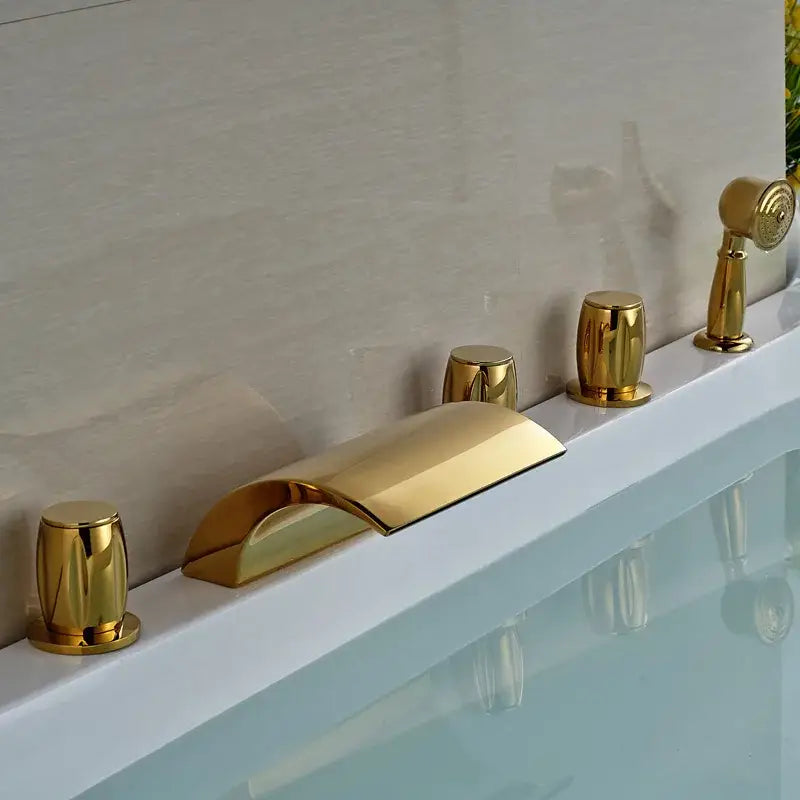 Modern golden widespread brass bathtub faucet with handheld shower featuring curved spout and three cylindrical handles