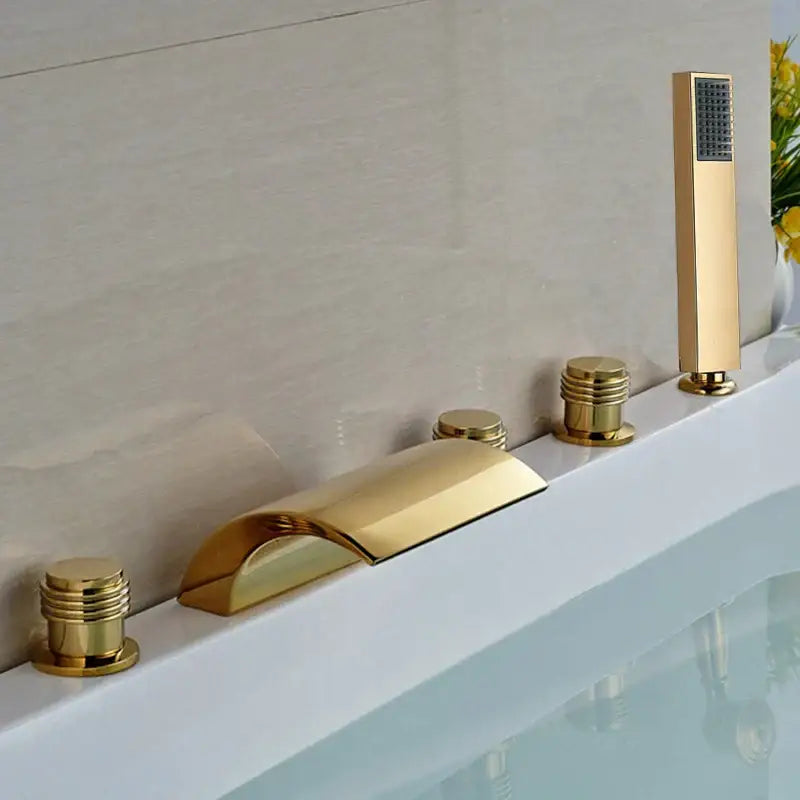 Modern golden widespread brass bathtub faucet with three cylindrical handles and integrated handheld showerhead
