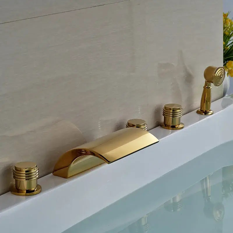 Modern golden widespread brass bathtub faucet with sleek curved spout and three cylindrical handles for bathroom use