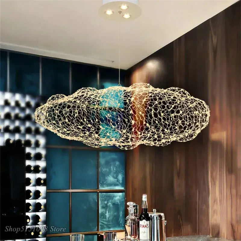 A modern golden wire mesh decorbites cloud pendant light with an illuminated interior for bedroom decor