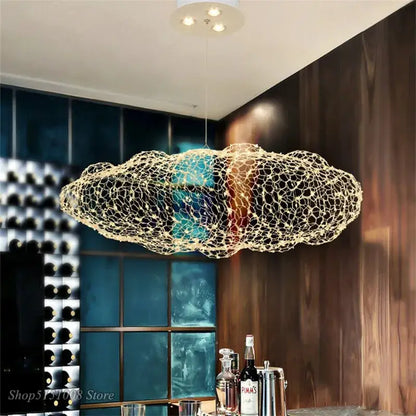 A modern golden wire mesh decorbites cloud pendant light with an illuminated interior for bedroom decor