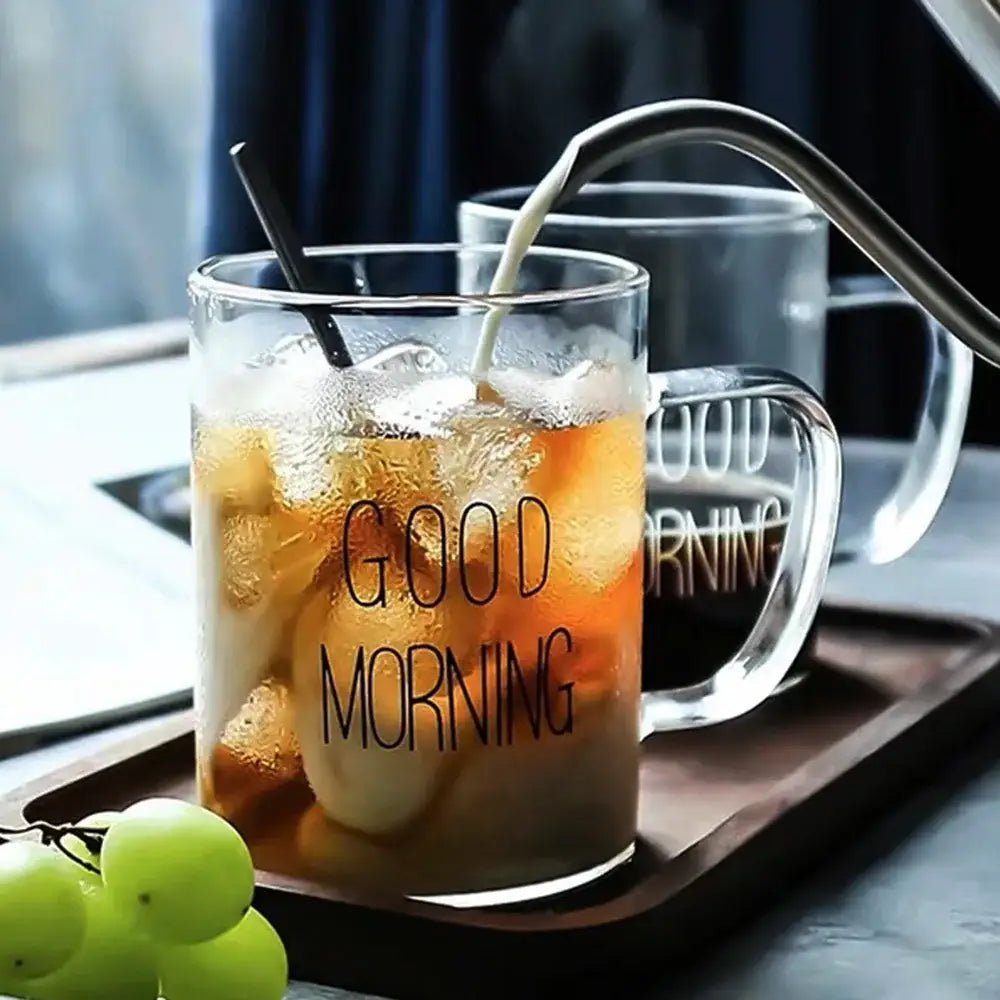 Clear glass mug with good morning printed in black filled with iced coffee by decorbites good morning glass tumbler