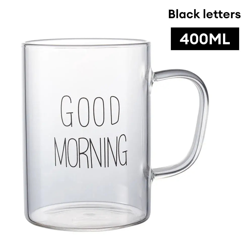 Modern good morning glass mug with clear glass and sleek curved handle featuring decorbites good morning print
