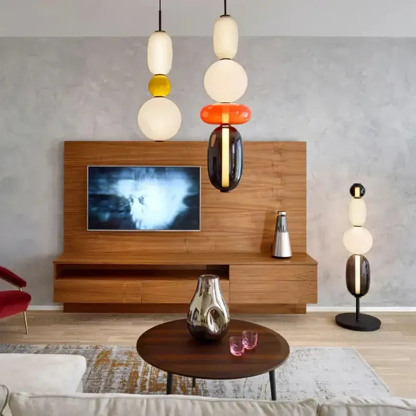 Modern gradient glass pendant light with stacked colorful spherical bulbs in white yellow orange and black for dining room