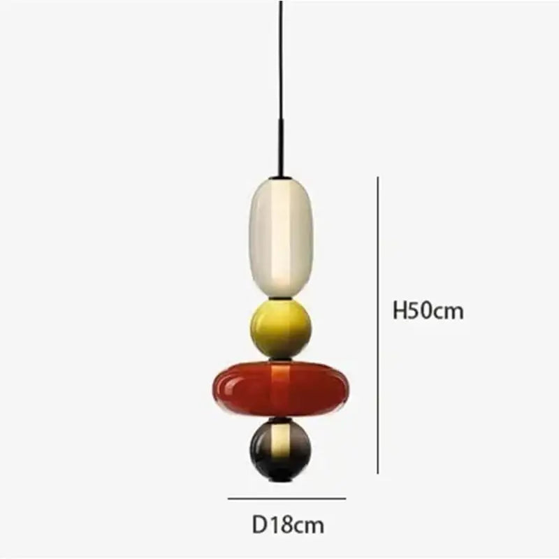 Modern gradient glass pendant light with stacked cream, yellow, red, and black orbs and sleek black cord for dining room