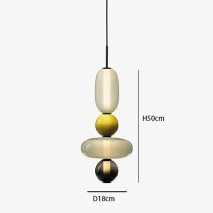 Modern gradient glass pendant light with stacked cream yellow and black glass orbs and sleek black cord for dining room
