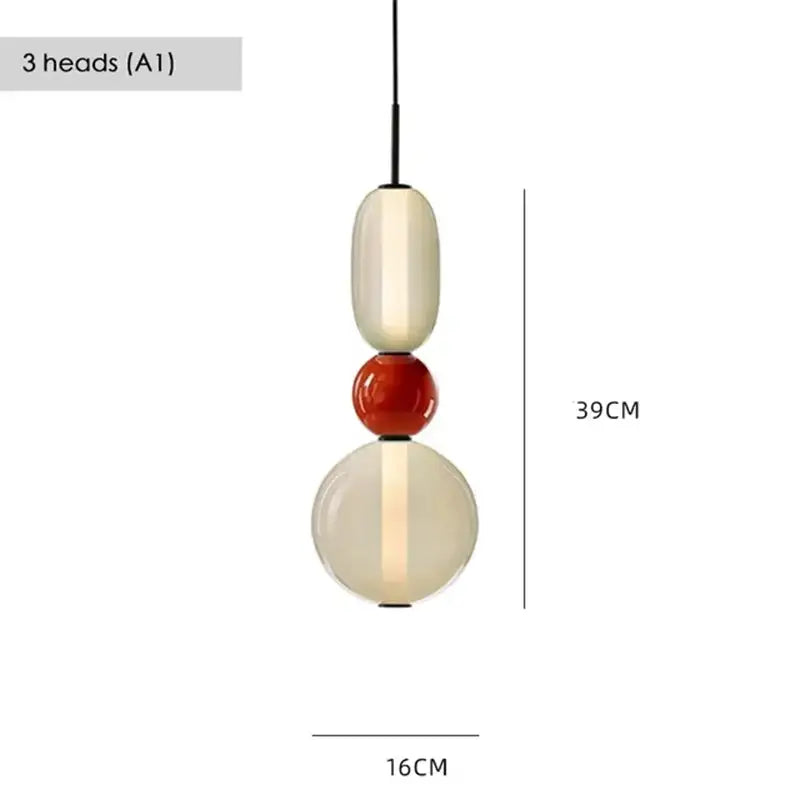 Modern gradient glass pendant light with three stacked cream, glossy red, and translucent orbs for dining room use