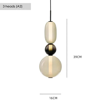 Modern gradient black and white glass pendant light with three stacked orbs featuring a warm glow for dining room