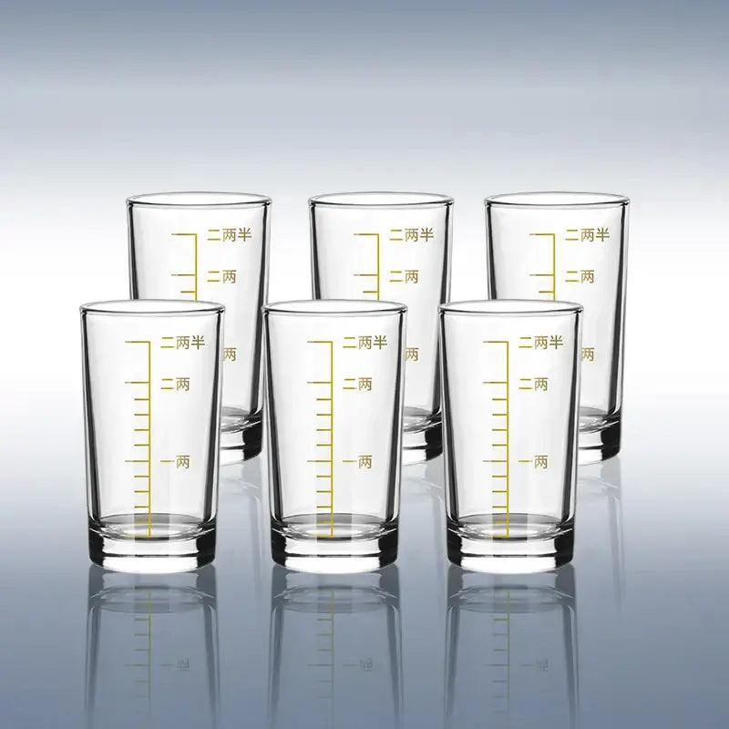 Clear glass spirit set brandy cups with gold-colored chinese measurement markings for modern dining use