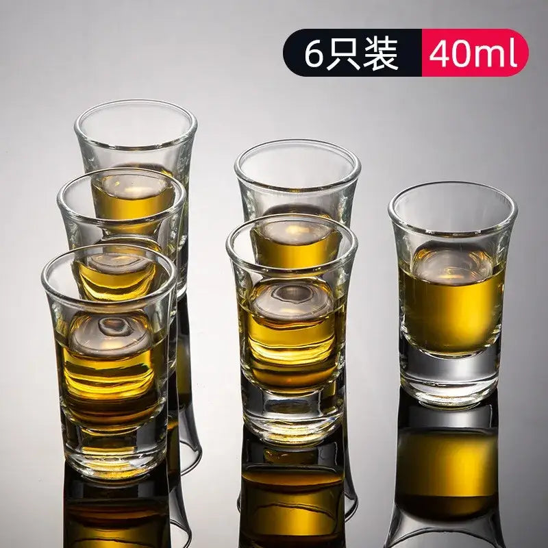 Set of six clear glass spirit brandy cups each holding 40ml golden liquid in modern graduated design