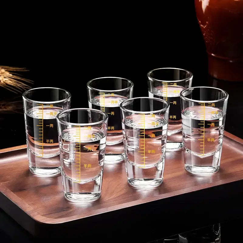 Set of six clear glass brandy cups with yellow Chinese measurement markings on a wooden tray glass spirit set