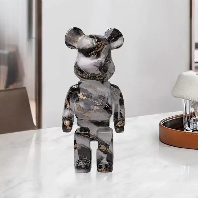A sleek black and gold marble-patterned decorbites graffiti bear 27cm figurine used as a modern living room money jar
