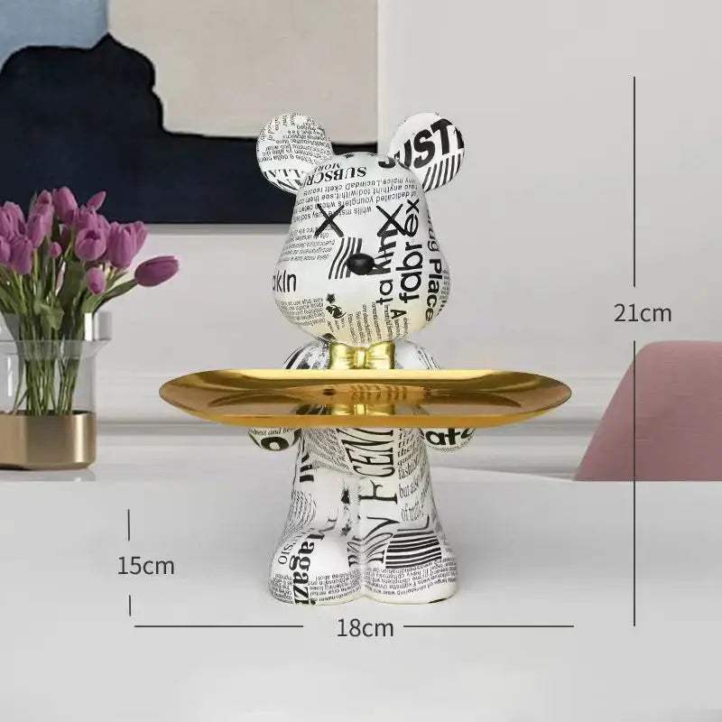 Modern graffiti bear figurine in white and black newspaper print with a gold tray for living room decor storage