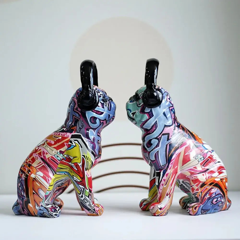 Two colorful graffiti bulldog sculptures with glossy black headphone earcups for modern living room decor