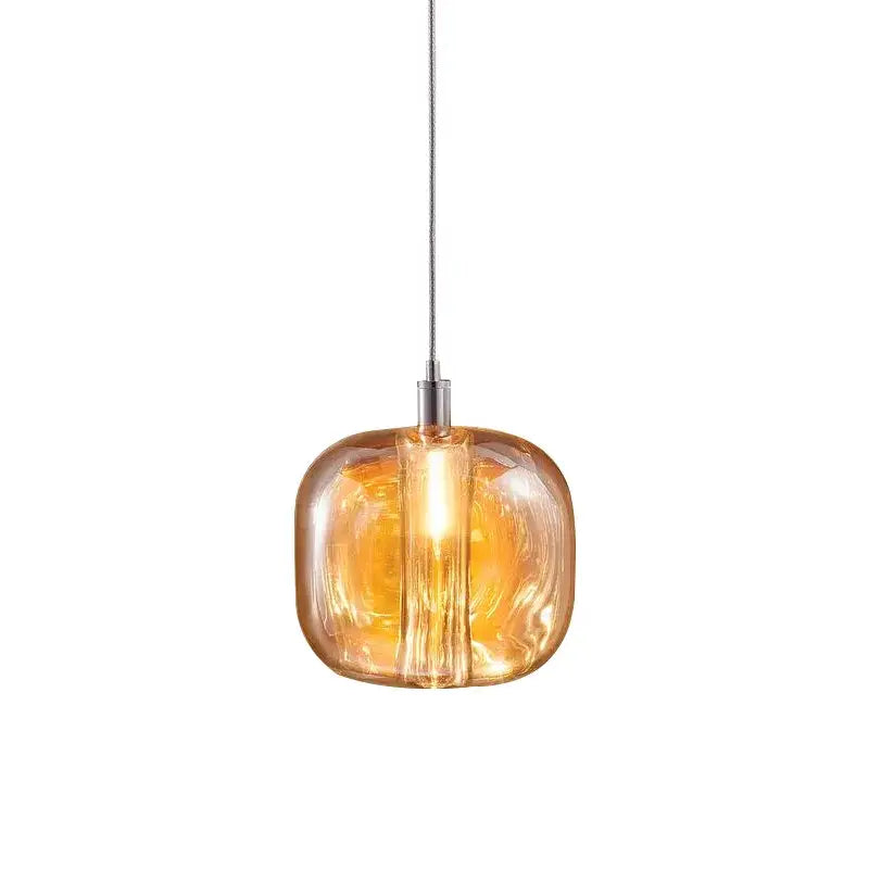 Warm amber glass pendant lights with sleek rounded design and metallic suspension for decorbites light luxury