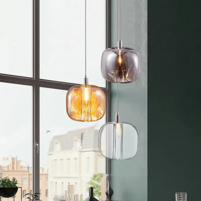 Three modern pendant lights with frosted amber smoky gray and clear glass shades for bedroom kitchen decorbites light luxury