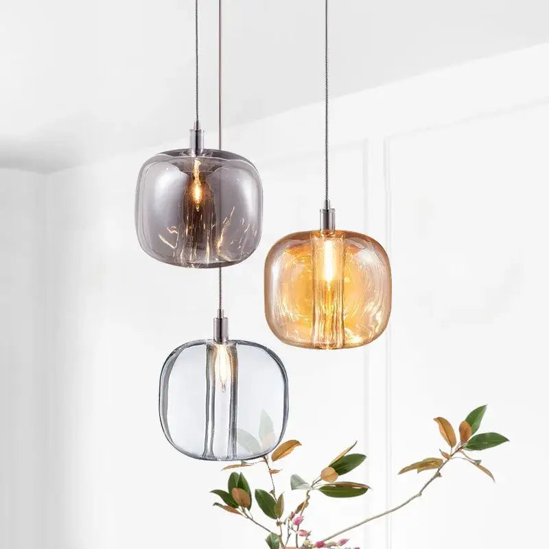 Three modern pendant lights with frosted glass shades in gray amber and clear hues for bedroom kitchen decorbites light luxury