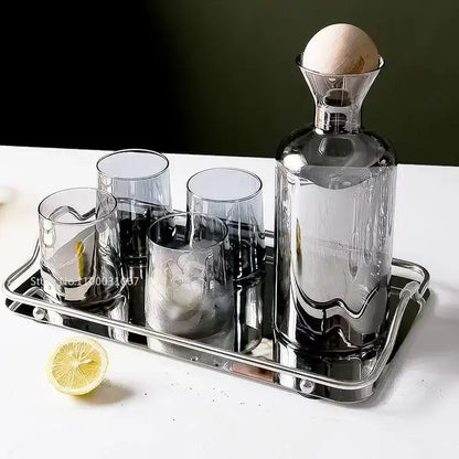 A sleek modern gray amber glass water pitcher with wood stopper and matching glasses on a metallic tray decorbites gray amber