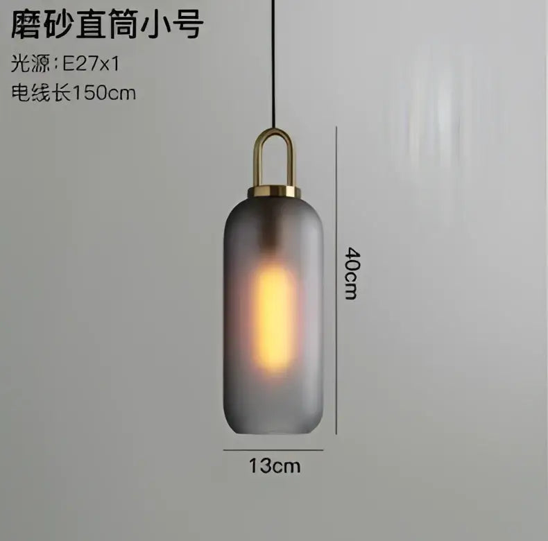 Modern gray and brass glass pendant light fixture with frosted glass and brass top for kitchen lighting