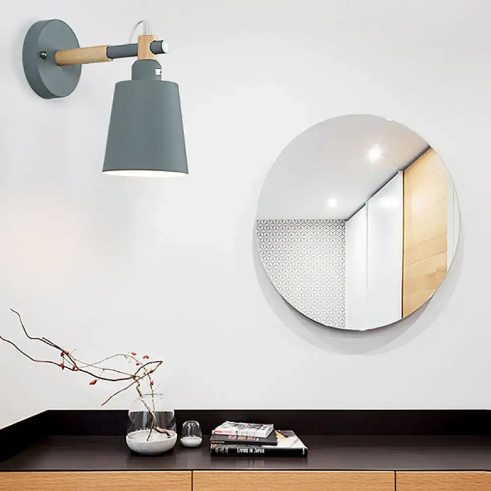 Modern gray and wood wall sconce light with matte metal shade designed as a bedroom wall sconce light fixture