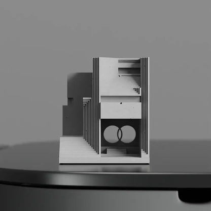 Minimalist white architectural model with layered panels and circular motif for modern gray concrete brian family cemetery decor