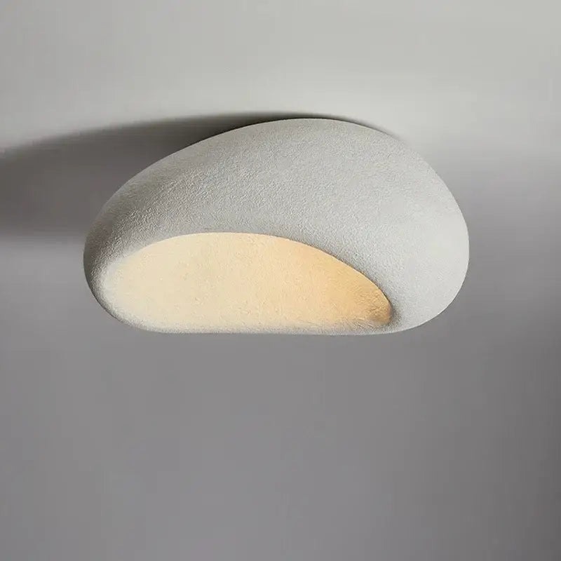 A sleek matte white stone-shaped modern gray concrete cream ceiling lamp chandelier with warm glow for bedroom decorbites cream ceiling