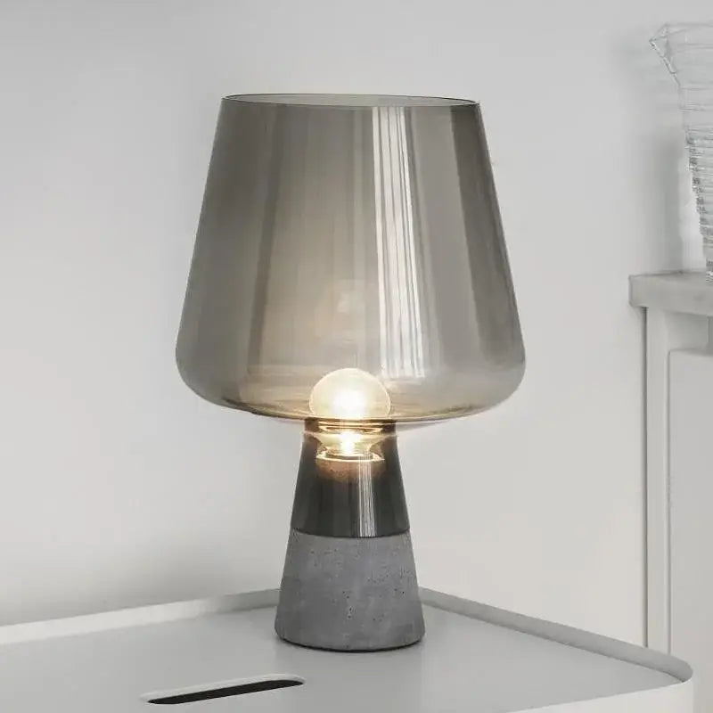 Modern gray glass and concrete table lamp with translucent shade and metallic accent band for bedroom decorbites leimu amber use