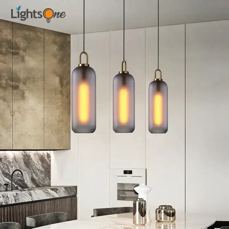 Three modern pendant lights with frosted gray glass ball shades and brass accents for dining room decorbites glass ball pendant