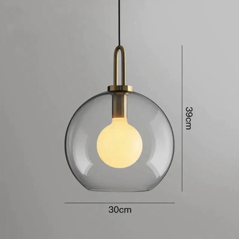 Modern gray glass ball pendant lights with brass hardware and warm exposed bulb for dining room decorbites glass ball