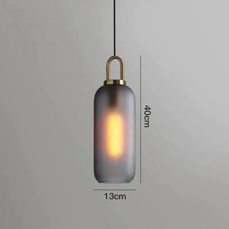 Modern gray glass ball pendant light with frosted glass, brass accents, and edison bulb for dining room decorbites glass ball pendant