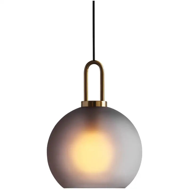 Modern gray glass ball pendant lights featuring frosted spherical shade and brass u-shaped fixture for dining room decorbites glass ball pendant
