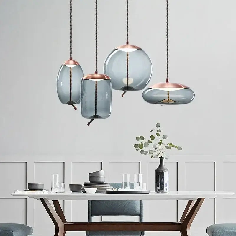 Modern gray glass chandelier knot pendant with frosted gray shades and rose gold accents for dining room lighting
