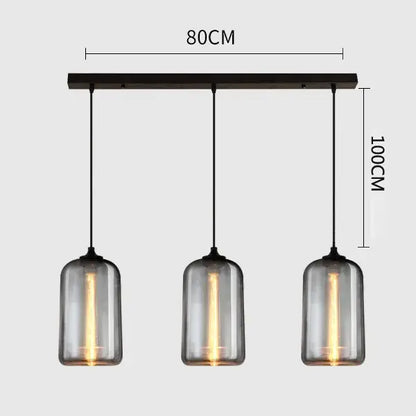 Modern gray glass pendant light set of 4 with three smoked cylindrical shades and dark metal bar for dining room lighting