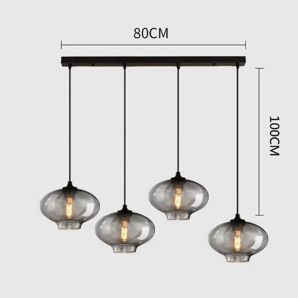 Modern black metal pendant light with four hanging smoked gray glass globes ideal for dining room lighting