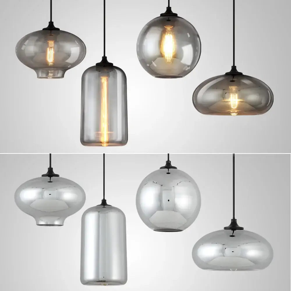 Set of 4 modern gray glass pendant lights with frosted and mirrored finishes and exposed filament bulbs for dining room