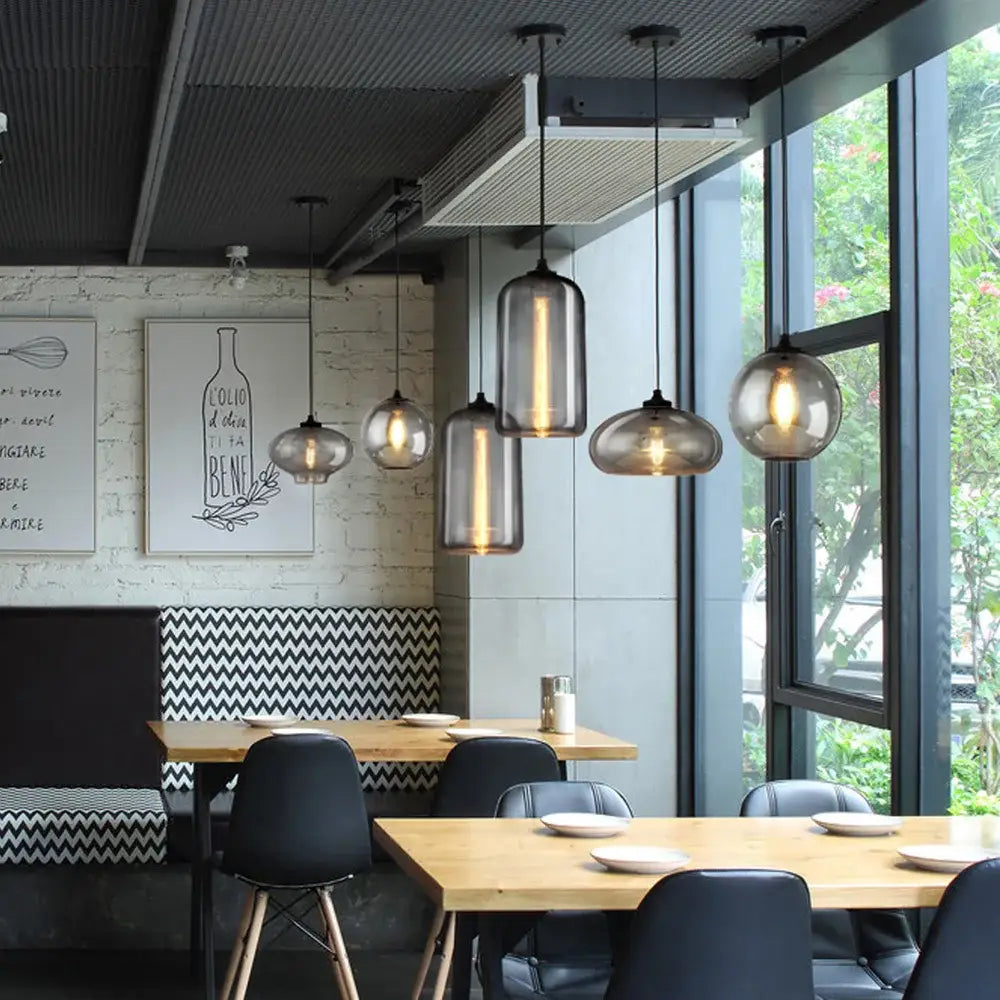 Modern gray glass pendant light set of 4 with smoked glass and warm filament bulbs for dining room lighting