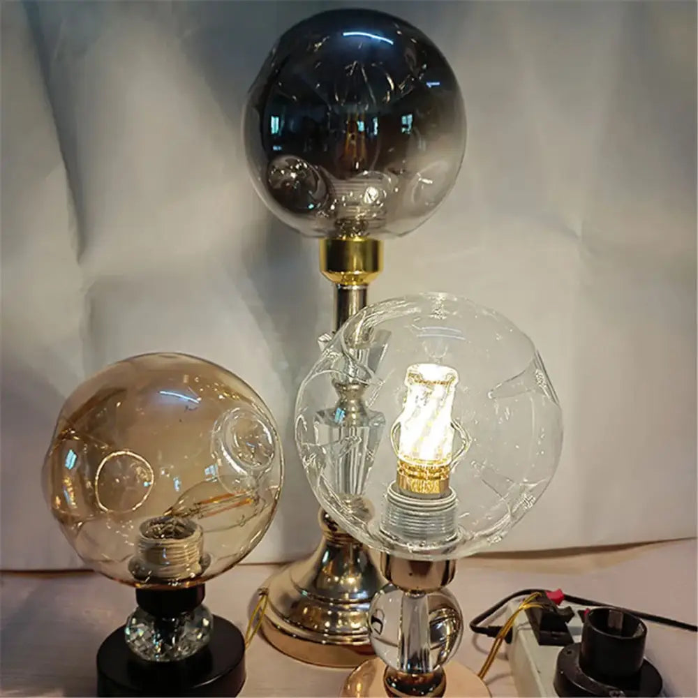 Modern gray glass shade replacement spherical lamp covers with metallic bases featuring one lit clear globe bulb