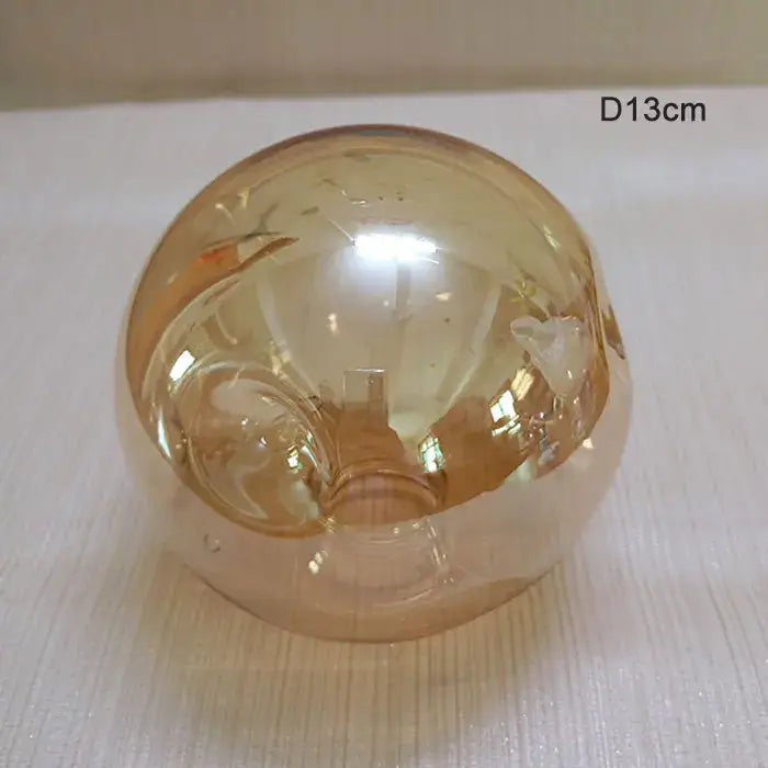 Modern gray glass shade replacement featuring a translucent amber glass globe with subtle internal etched patterns