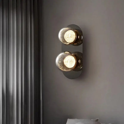 Modern double-bulb wall lights with frosted gray glass globes and brushed brass accents for living room wall lighting