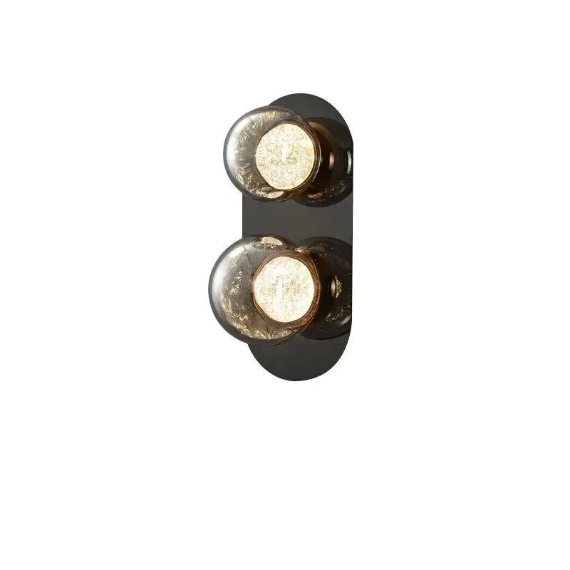 Modern black wall sconce with two spherical textured glass bulbs featuring warm interior lighting for living room wall lights