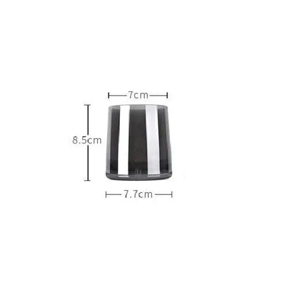 Modern gray glass water pitcher with stainless steel lid and sleek cylindrical glass candle holder with black and silver stripes