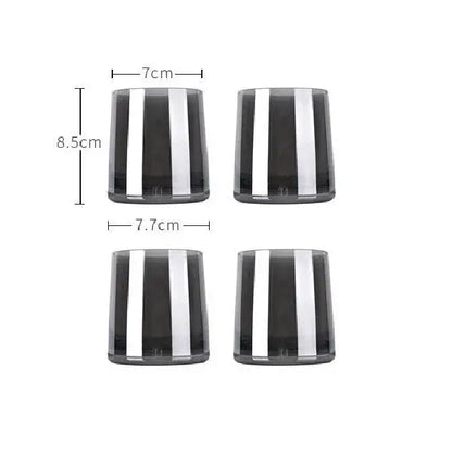 Set of four sleek dark gray glass tumblers with bold vertical silver stripes for modern glass water use