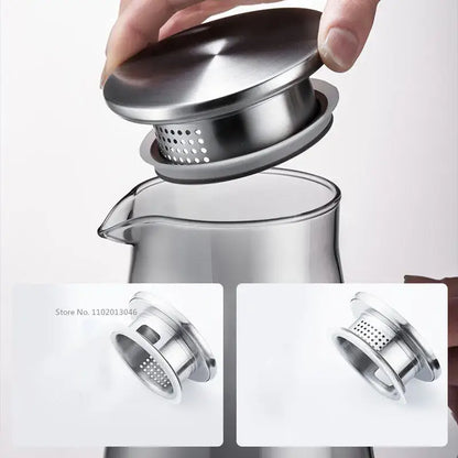 Modern gray glass water pitcher with stainless lid and stainless steel perforated tea infuser for brewing glass water